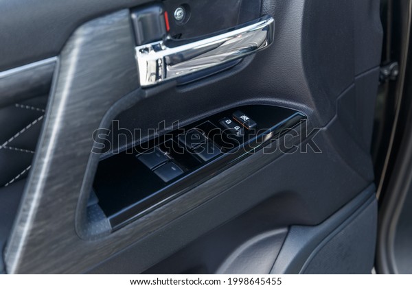 Power window control\
panel. Modern car interior. Soft focus. Modern car illuminated\
dashboard. Luxurious car instrument cluster. Close up shot of\
automobile instrument\
panel