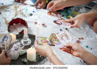the power of the women's circle, girls hold candles in their hands, cards and candles