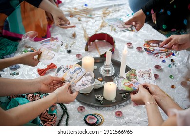 the power of the women's circle, girls hold candles in their hands, cards and candles