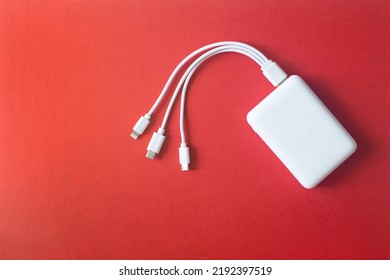 Powerbank on red background. Powerbank with different connectors. - Shutterstock ID 2192397519