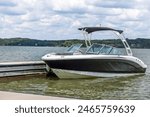 Powerboat at private boat dock on freshwater lake.