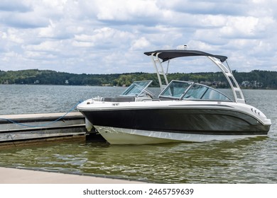 Powerboat at private boat dock on freshwater lake. - Powered by Shutterstock