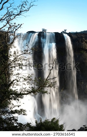 Powerful Athirappilly Falls in Vertical Composition, Kerala. India's most stunning waterfalls on Chalakudy River, ideal for travel, nature, and serene landscape themes.