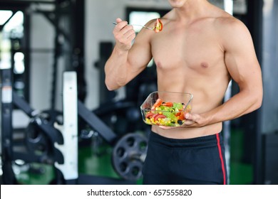 Powerful Athletic Man With Great Physique Eating A Healthy Salad.