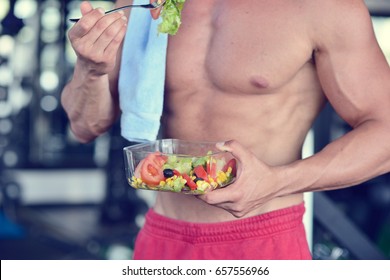 Powerful Athletic Man With Great Physique Eating A Healthy Salad.