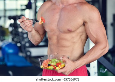 Powerful Athletic Man With Great Physique Eating A Healthy Salad.