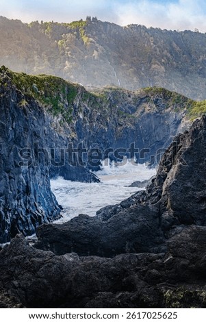 Powerful Atlantic waves collide with the dramatic volcanic rock formations along Sao Jorge Island rugged coastline. When calm, these basalt enclosures form natural swimming pools at Faja dos Cubres