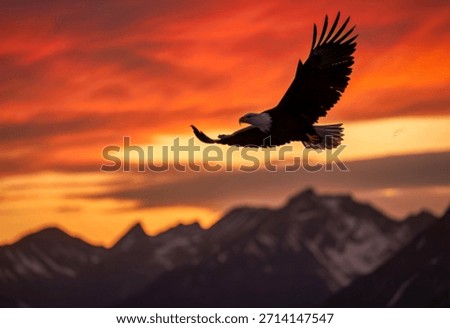 A powerful bald eagle glides gracefully through a vibrant orange and red sunset, silhouetted against a dramatic mountain landscape.