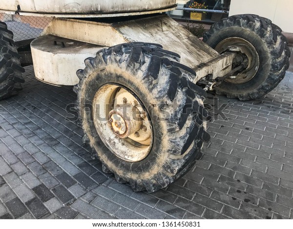 Powerful big wheels with tread and tires\
of off-road construction equipment, tractors,\
cars.