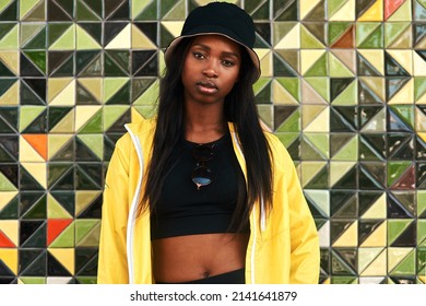 I Am Powerful And Confident. Cropped Portrait Of An Attractive Young Woman Standing Alone Against A Brightly Tiled Wall During The Day.