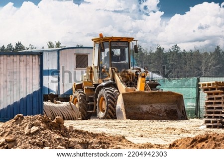 Powerful crawler bulldozer close-up at the construction site. Construction equipment for moving large volumes of soil. Modern construction machine. Road building machine