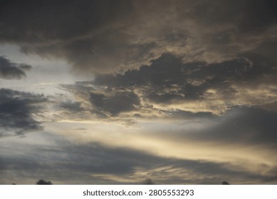 Powerful Dark Clouds Hanging Over the Ocean Horizon with Colorful Sunset Twilight Sky
