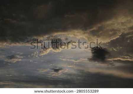 Powerful Dark Clouds Hanging Over the Ocean Horizon with Colorful Sunset Twilight Sky
