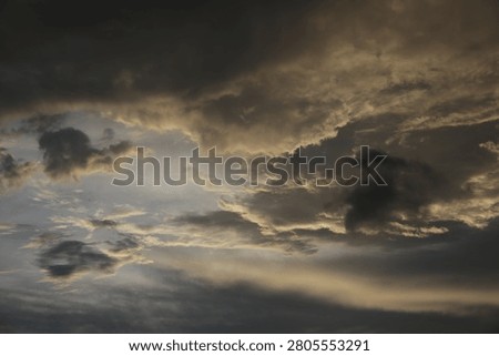 Powerful Dark Clouds Hanging Over the Ocean Horizon with Colorful Sunset Twilight Sky
