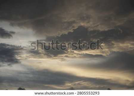 Powerful Dark Clouds Hanging Over the Ocean Horizon with Colorful Sunset Twilight Sky
