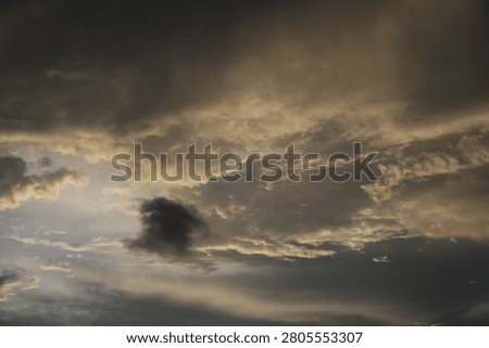 Powerful Dark Clouds Hanging Over the Ocean Horizon with Colorful Sunset Twilight Sky
