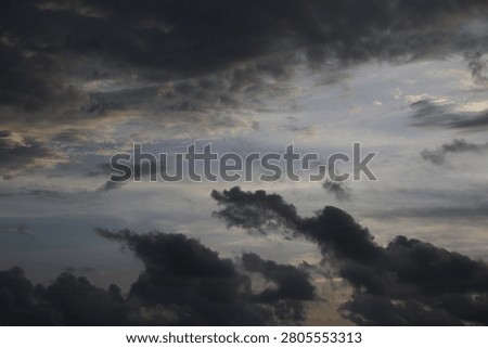 Powerful Dark Clouds Hanging Over the Ocean Horizon with Colorful Sunset Twilight Sky

