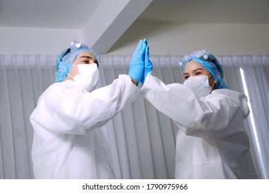 Powerful and energy of Medical team in Personal Protective Equipment or PPE clothing and Healing for patient infected with the Covid-19 virus is two palm coordination. closes up on hand - Shutterstock ID 1790975966
