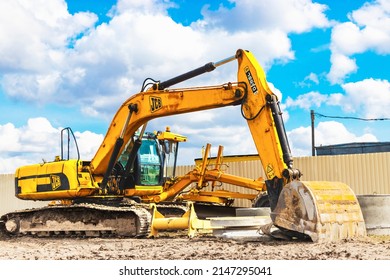 Powerful excavator work on a construction site, sunny blue sky in the background. Construction equipment for earthworks. JCB. Belarus, Soligorsk, April 2022