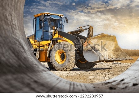 Powerful front wheel loader or bulldozer working on a quarry or construction site. earthworks in construction. Powerful modern equipment for earthworks