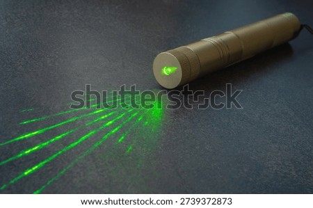 Powerful green laser pointer.Dazzle with a laser.A light beam.