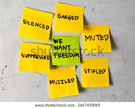 A powerful image featuring sticky notes with words like "silenced," "gagged," and "suppressed," surrounding a green note stating "We Want Freedom," symbolizing the struggle against oppression.