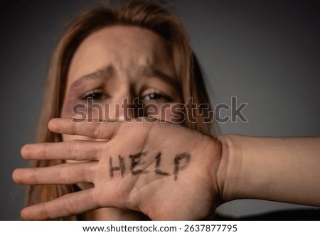 A powerful image highlighting the plea for help in the face of domestic violence, emphasizing the urgent need for awareness and support.