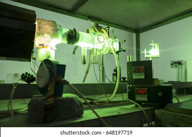 Powerful industrial green laser equipment in a laboratory for physics research. Solid State Physics lab. Light amplification by stimulated emission of radiation (LASER).