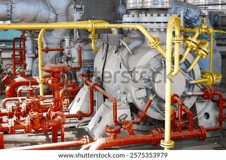 Powerful industrial pump operates efficiently within a chemical plant's complex piping network during regular operations