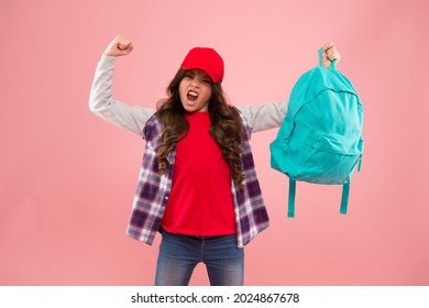 Powerful kid. Carrying things in backpack. Learn how fit backpack correctly. Girl little fashionable kid carry backpack. Useful fashion accessory. Schoolgirl red cap long hair with school backpack
