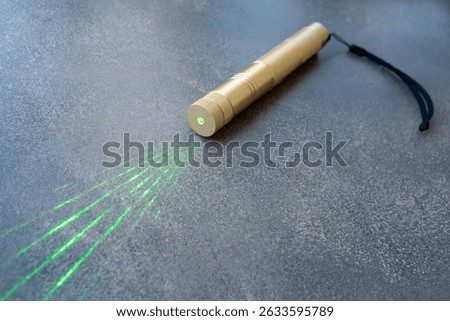 Powerful laser pointer.The green laser is on the table.