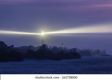 Powerful lighthouse illuminated at night,Ushant island, France