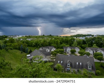 A powerful lightning bolt electrifies the evening sky above a U.S. neighborhood - Powered by Shutterstock