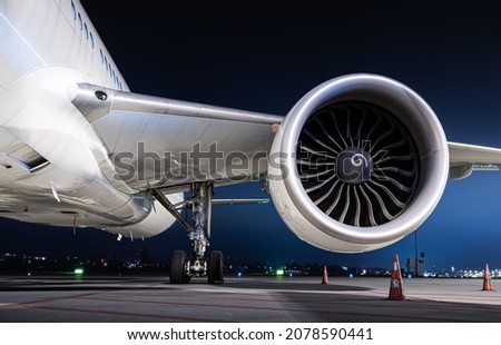 Powerful long-haul airliner  jet engine isolated at night. Together with the well lit landing gear, this makes a nice aviation wallpaper