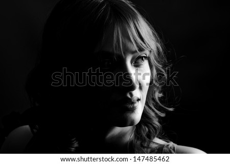 powerful low key image of a beautiful woman in monochrome
