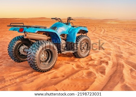 Powerful modern quad bike among the Arabian sand dunes of the Rub Al Khali desert in Dubai