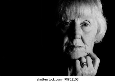 Powerful Monochrome Low Key Image Of A Sad Elderly Woman