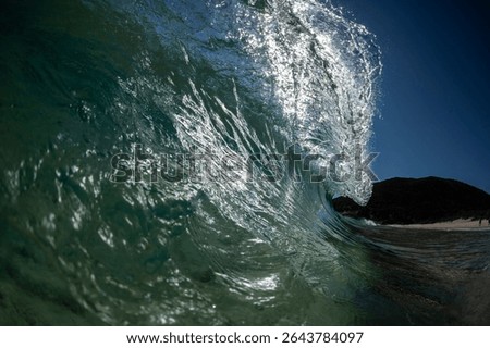 A powerful ocean wave just before it crashes, captured close from the water.
