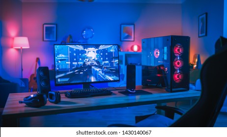 Powerful Personal Computer Gamer Rig with First-Person Shooter Game on Screen. Monitor Stands on the Table at Home. Cozy Room with Modern Design is Lit with Pink Neon Light. - Shutterstock ID 1430140067