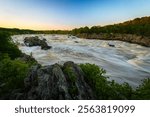 The powerful Potomac River at the Great Falls Park, National Park in Virginia, USA, on a Summer Day with blue Sky - Long-Time Exposure with flowing Water