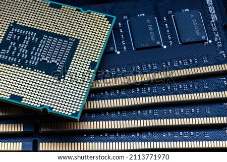 Powerful processor against the background of DDR DIMM RAM modules. Computer upgrade kit.