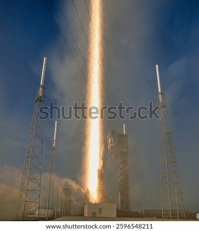 A powerful rocket blasts off from a launchpad, leaving a trail of smoke and fire in its wake. A rocket launching into space. Rocket space ship. Elements of this image furnished by NASA