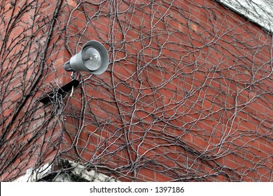 Powerful security light on an old brick building.