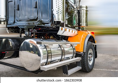 Powerful Shiny Big Rig Semi Truck Tractor In Black And Orange With Polisher Aluminum Fuel Tanks And Steps And Another Accessories Ready To Go For Industrial Heavy Freight 