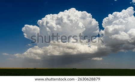 Powerful storm clouds develop, bursting high into the atmosphere with epic texture and shadow, creating a dramatic, moody sky full of motion, danger, and the raw beauty of nature’s weather