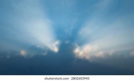 Powerful sun rays pierce through a dramatic cloudy sky, creating a sense of awe and wonder.