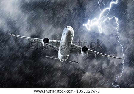 Powerful thunderstorm lightning strike and heavy rain in the sky passenger airplane