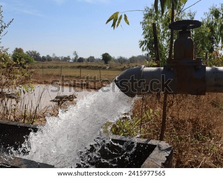 powerful water flowing from a large pipe pump  for agricultural