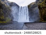 Powerful skógafoss waterfall in iceland, a breathtaking natural wonder with cascading water, mist, and rugged beauty