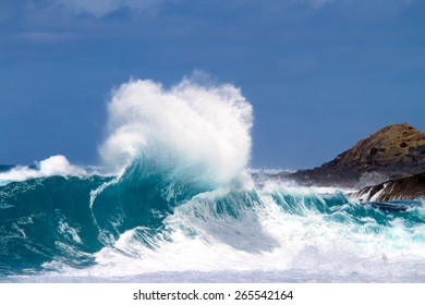 Powerful Wave Breaks Along The Shore